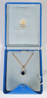 Lot 58 - An 18ct gold necklace suspending yellow metal,...