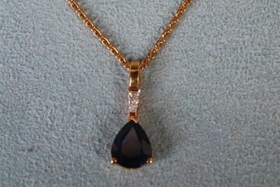 Lot 58 - An 18ct gold necklace suspending yellow metal,...