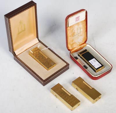 Lot 87 - A group of four assorted Dunhill yellow metal...
