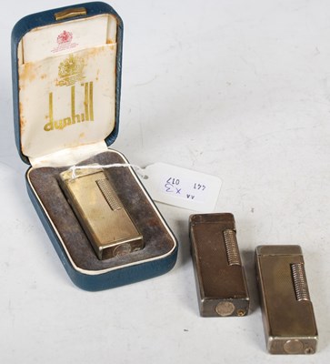Lot 88 - A group of three Dunhill white metal Rollagas...