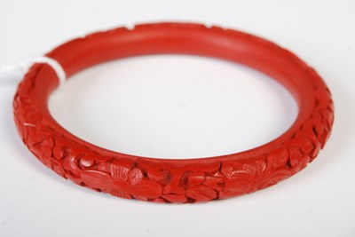 Lot 105 - A Chinese carved red lacquer bangle, 8.2cm...
