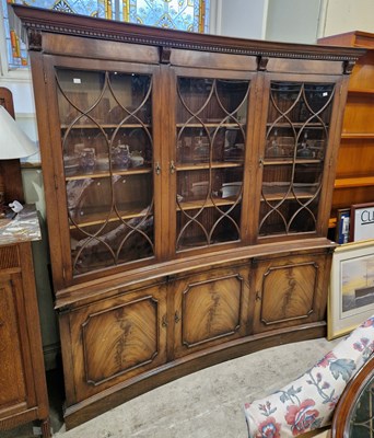 Lot 555 - A reproduction two part curved bookcase, the...