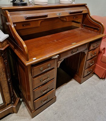 Lot 567 - An antique mahogany rolltop desk.