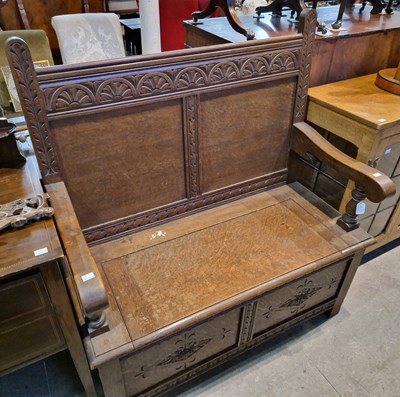 Lot 582 - A 19th century oak carved settle, the hinged...