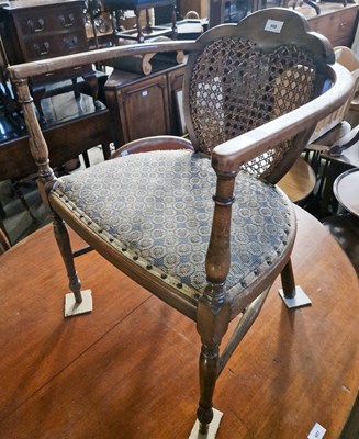 Lot 608 - An antique mahogany cane back armchair.