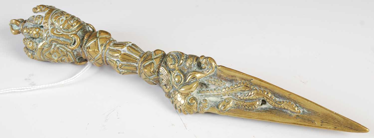 Lot 101 - An antique Tibetan brass ritual knife/ dagger,...