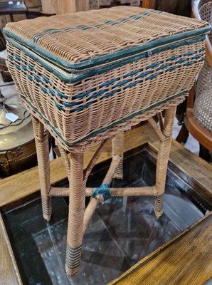 Lot 644 - A vintage wicker sewing box, raised on four...