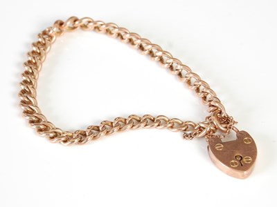 Lot 450D - A 9ct gold bracelet with heart-shaped locket,...