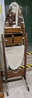 Lot 654 - A 20th century oak cheval mirror.