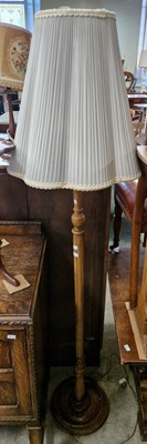 Lot 657 - A 20th century oak standard lamp.