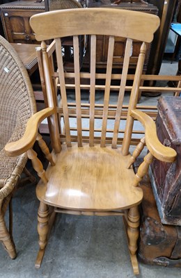 Lot 688 - A 20th century blonde wood rocking chair.