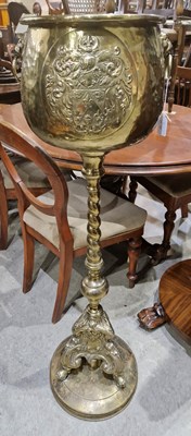 Lot 694 - An antique brass jardiniere stand with lion...