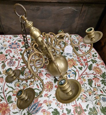 Lot 706 - An antique brass six light chandelier.