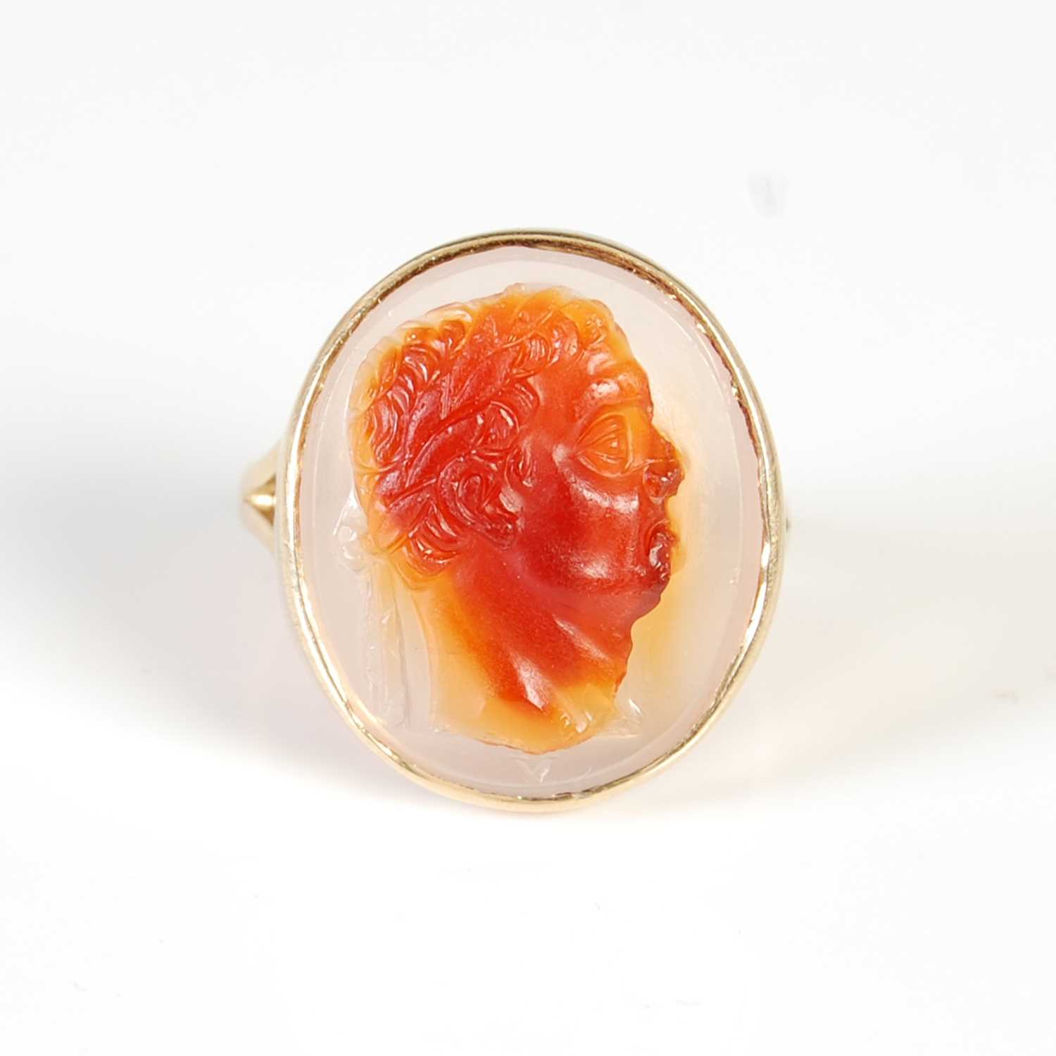 Lot 451 - A yellow metal cameo set ring, set with an...