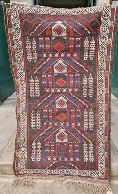 Lot 763 - A small Persian rug, the brown ground centred...