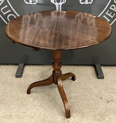 Lot 814 - A late 19th century oak circular snap-top...