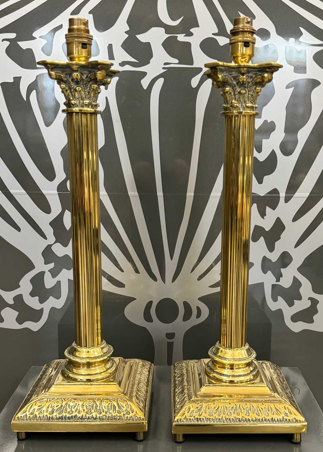 Lot 427 - A pair of brass Corinthian column table lamps.