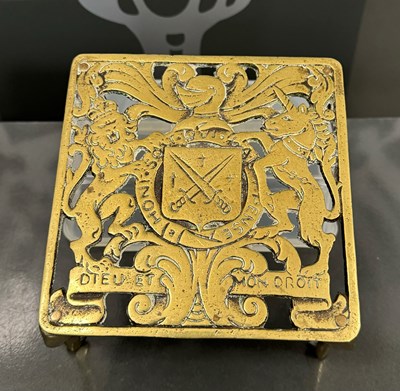 Lot 434 - An antique brass trivet with Royal armorial...