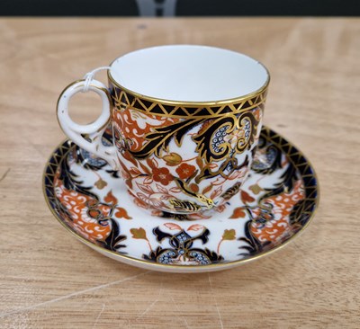 Lot 313 - A Royal Crown Derby cup and saucer, painted...