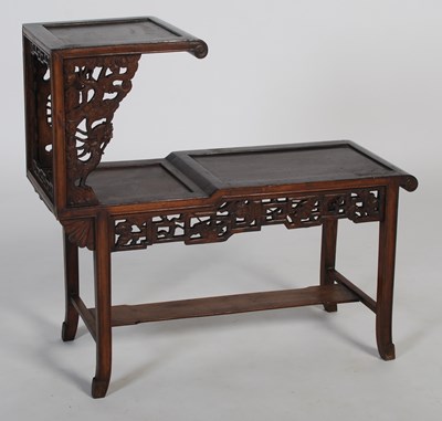 Lot 26 - A Chinese dark wood urn stand of asymmetric...