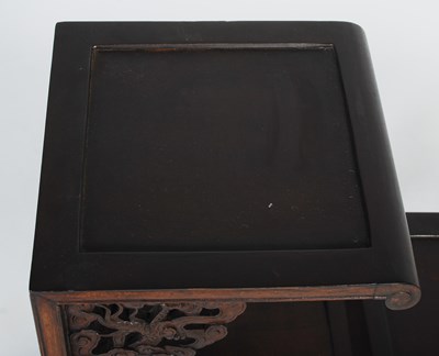Lot 26 - A Chinese dark wood urn stand of asymmetric...