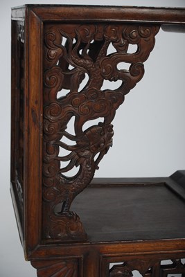 Lot 26 - A Chinese dark wood urn stand of asymmetric...