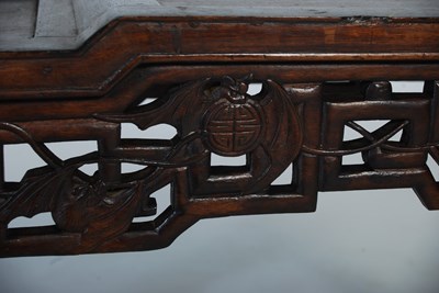 Lot 26 - A Chinese dark wood urn stand of asymmetric...