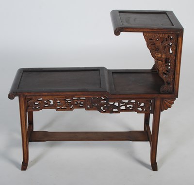 Lot 26 - A Chinese dark wood urn stand of asymmetric...