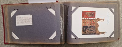 Lot 387 - A vintage postcard album containing 'Tuck's'...