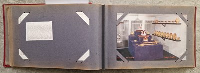 Lot 387 - A vintage postcard album containing 'Tuck's'...