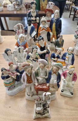 Lot 517 - A collection of Staffordshire ceramic figures...