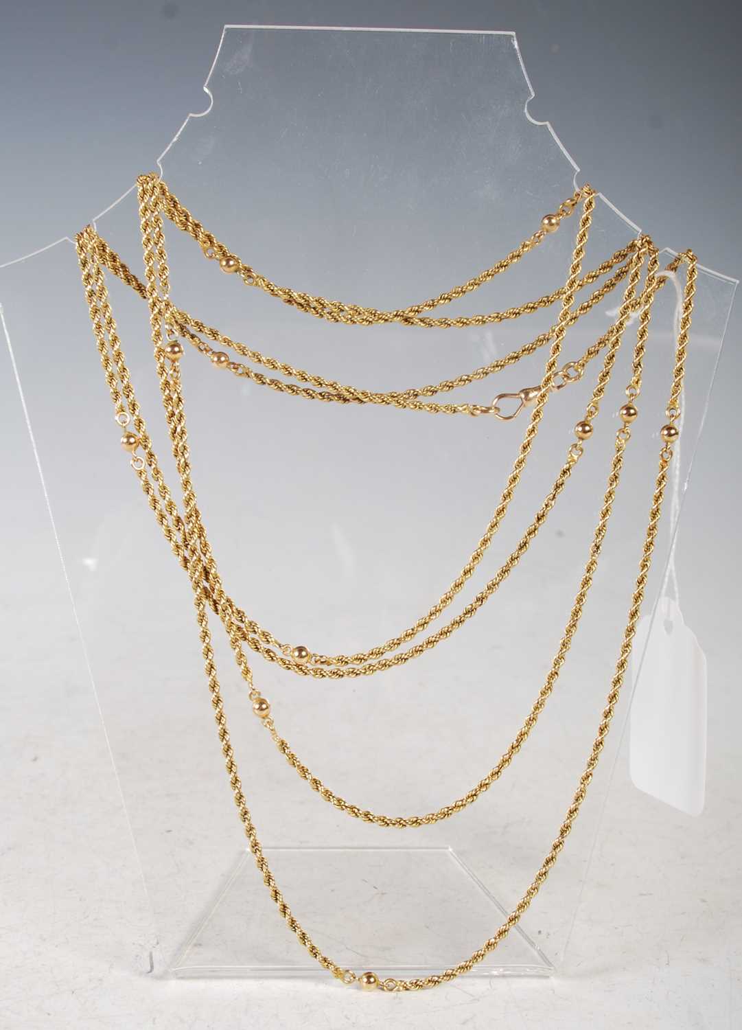 Lot 46 - A long yellow metal guard chain of rope twist...