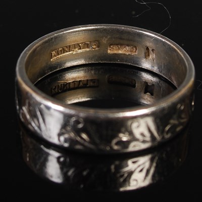 Lot 66 - A platinum ring, size N, 6 grams.