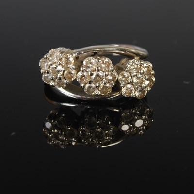 Lot 37 - An 18ct white gold and diamond triple cluster...