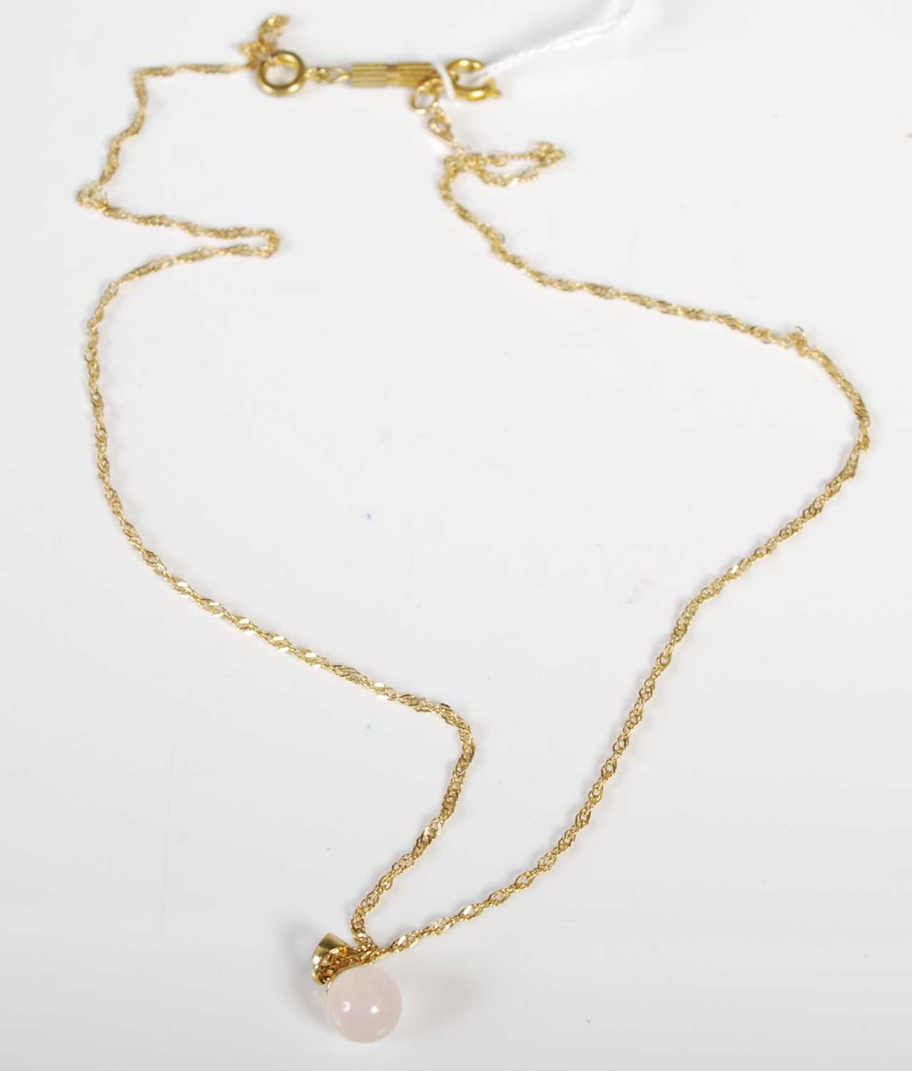 Lot 88 - A 9ct gold necklace suspending a circular...
