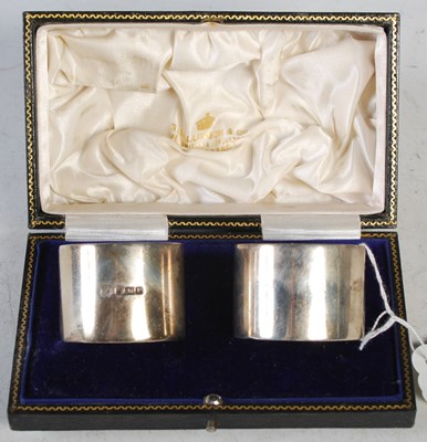 Lot 172 - A cased near pair of silver napkin rings, one...