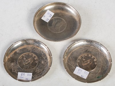 Lot 191 - A pair of Chinese silver coin-set dishes,...
