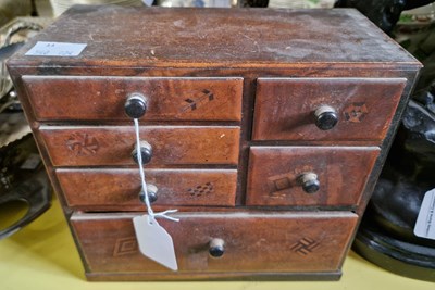 Lot 615 - A Japanese parquetry tabletop chest of drawers,...