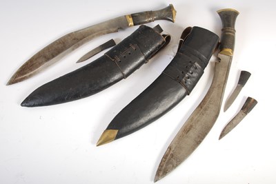 Lot 620 - Two Kukri knives in fitted leather scabbards,...