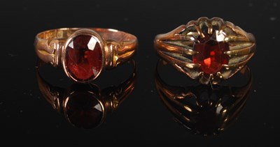 Lot 270 - Two 9ct gold and garnet set single stone rings,...