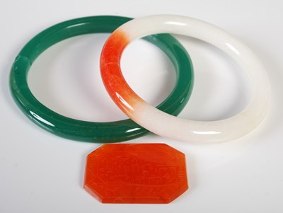 Lot 290 - Green stone bangle, a white and orange stone...