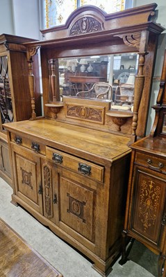 Lot 772 - A 19th century carved oak mirror-back...