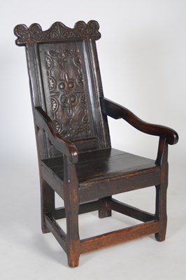 Lot 84 - An 18th century oak wainscot elbow chair, the...