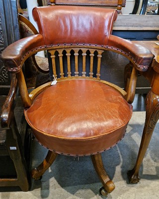 Lot 781 - A 20th century oak and red leather captain's...