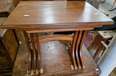 Lot 807 - A mid-century teak nest of three tables by G...