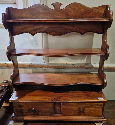 Lot 834 - A 20th century mahogany side shelf with three...