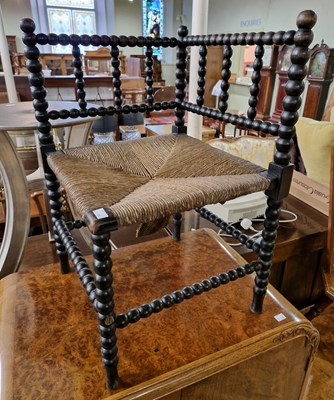 Lot 877 - An antique ebonised bobbin-turned corner chair...