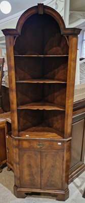 Lot 879 - A reproduction mahogany corner cupboard.