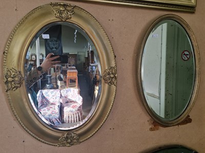 Lot 749 - A gilt framed oval bevelled wall mirror, 63cm...