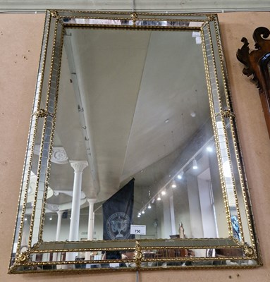 Lot 750 - A decorative cushion framed wall mirror, 80cm...